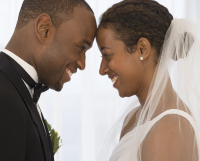 Bride and groom smiling at each other.