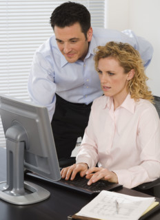 Businesspeople looking at computer.