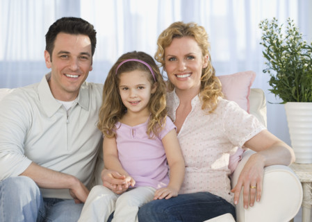 Portrait of family on sofa.