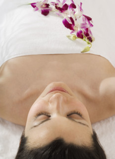 Woman laying on spa table.
