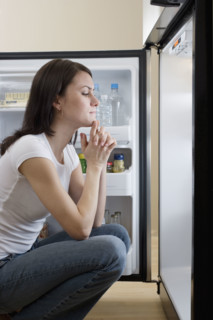 Woman looking in refrigerator.