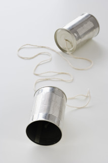 Tin cans connected by string.