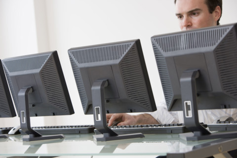 Businessman typing on computer.