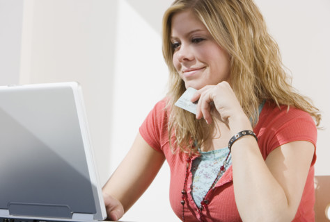 Woman shopping online with laptop.