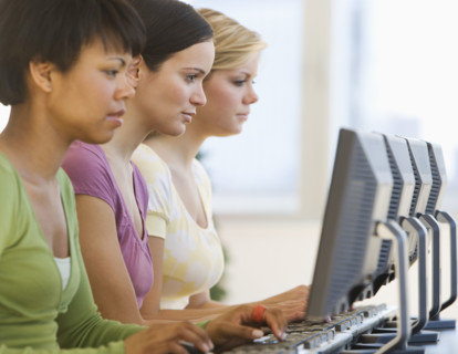Ethnic-ethnic women typing on computers.