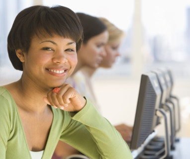 African woman in front of computers.