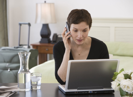 Businesswoman working in hotel room.