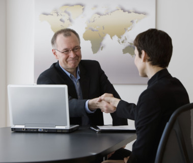 Businessman and businesswoman shaking hands.