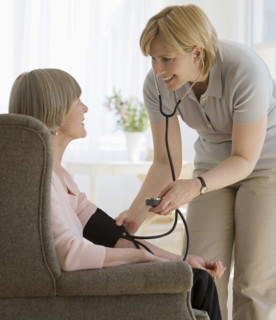 Senior woman having blood pressure taken.