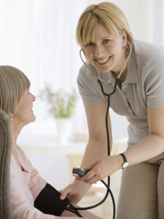Senior woman having blood pressure taken.