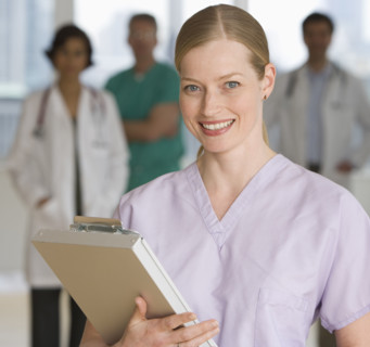 Female doctor holding chart.
