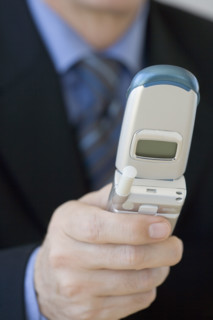 Businessman looking at cell phone.
