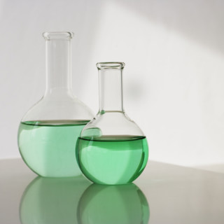 Two beakers with liquid.