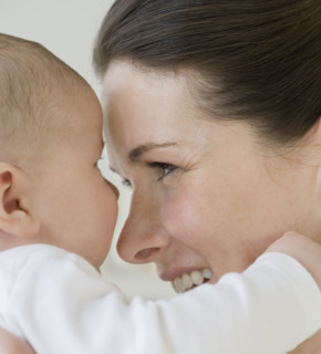 Mother smiling at baby.