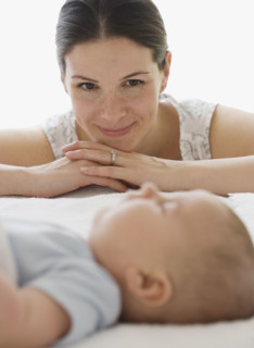 Mother watching baby sleep.