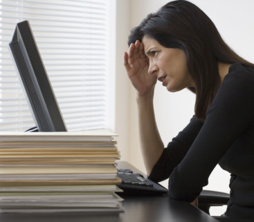Businesswoman looking at computer.
