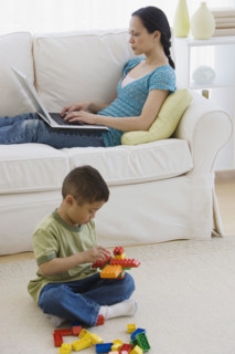 Asian mother and son relaxing in livingroom.