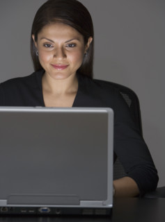 Indian businesswoman looking at laptop.