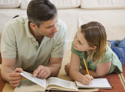 Father helping daughter with homework.