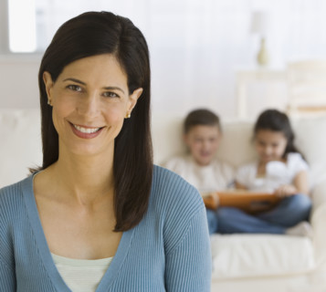 Mother with children in background.