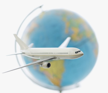 Model of airplane in front of globe.
