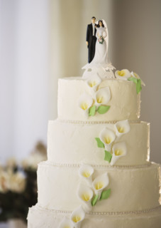Wedding cake with bride and groom figurines.
