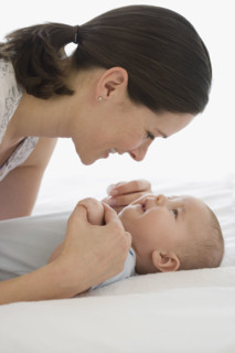 Mother smiling at baby.