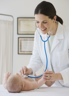Female doctor examining baby.