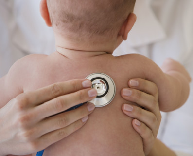 Doctor listening to baby’s lungs.