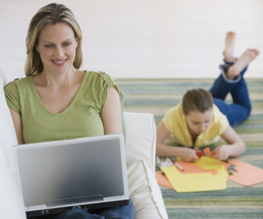 Mother and daughter relaxing in livingroom.