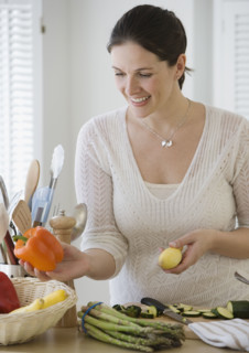 Woman chopping vegetables in kitchen.