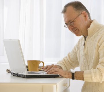 Man typing on laptop.