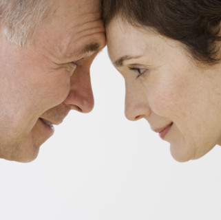 Close up of couple touching foreheads.