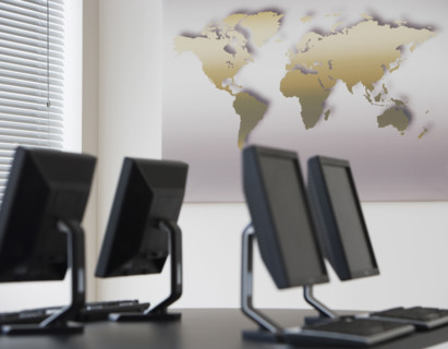 Table with computers in front of map.