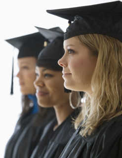 Multi-ethnic women wearing graduation cap and gown.