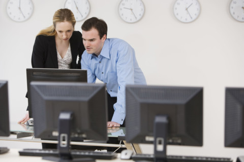 Businesspeople looking at computer.