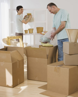 Couple unpacking moving boxes.