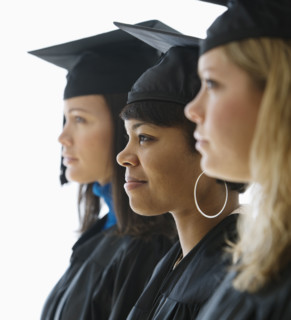Multi-ethnic women wearing graduation cap and gown.