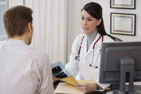 Female doctor talking to patient in office.