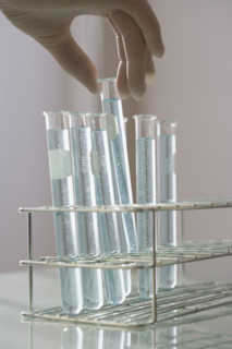 Scientist taking vial out of rack.