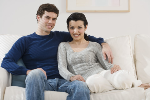 Portrait of couple on sofa.