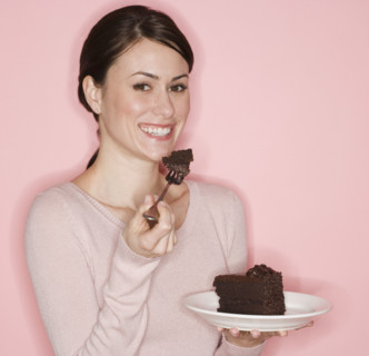 Portrait of woman eating cake.