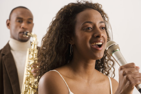 Woman singing into microphone.