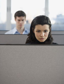 Businesspeople working in cubicles.