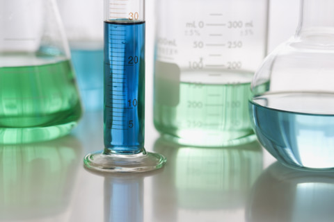 Close up of beakers with liquid.