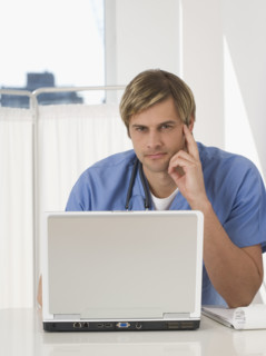 Portrait of male doctor with laptop.