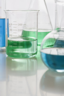 Close up of beakers with liquid.
