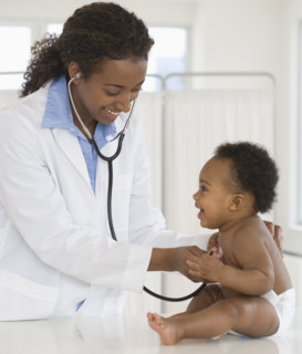 Female doctor examining baby.
