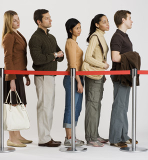 Group of people standing in line.