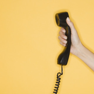 Woman holding telephone receiver.